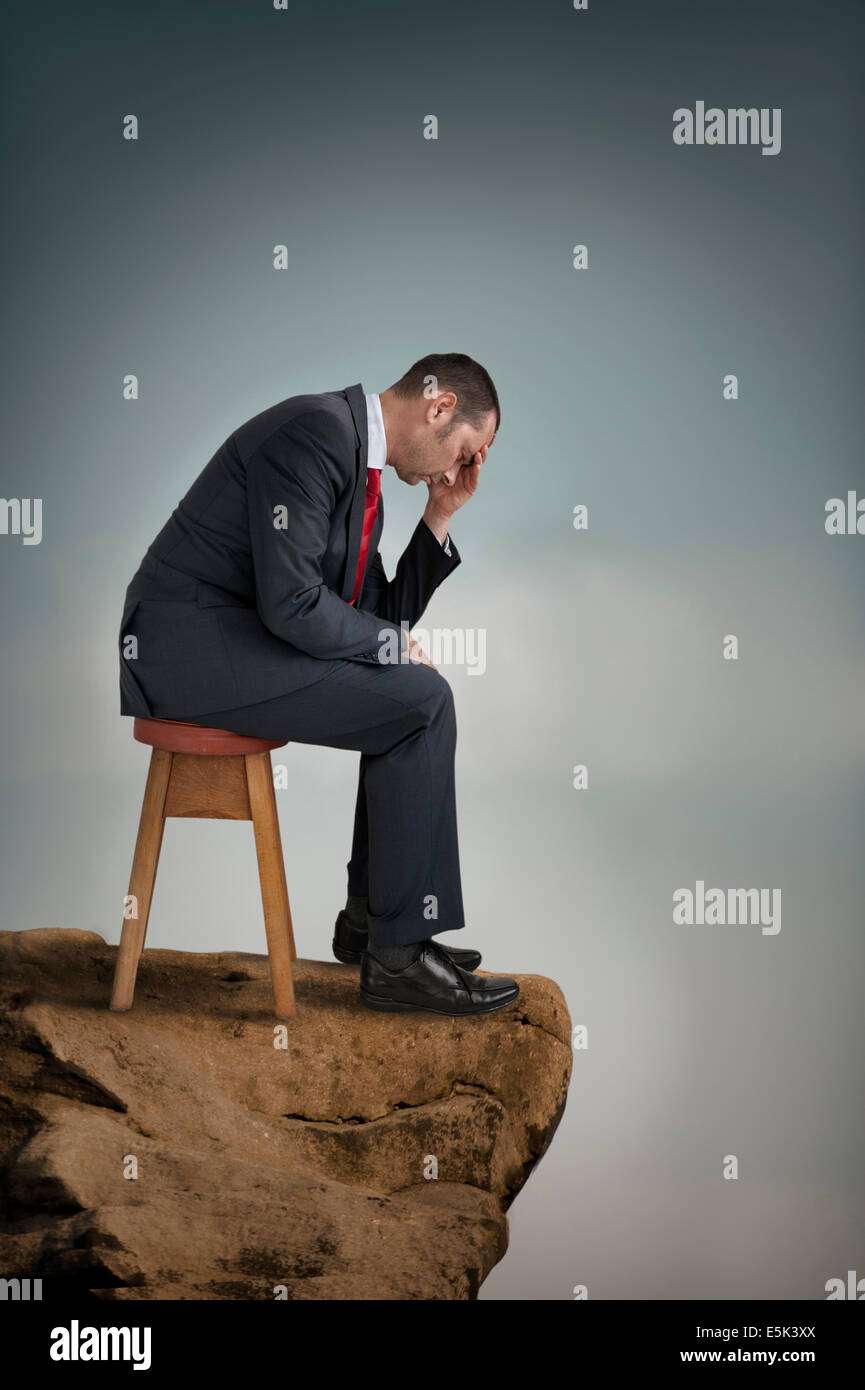depressed businessman suffering depression on a cliff ...
