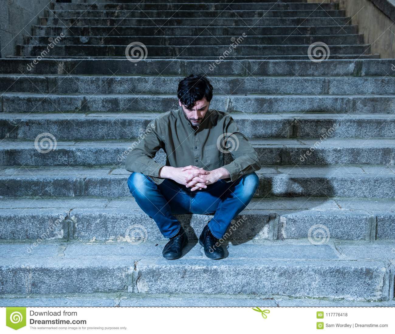 Depressed Man Sitting Out Side On Steps Feeling Tired And Sad. Stock ...