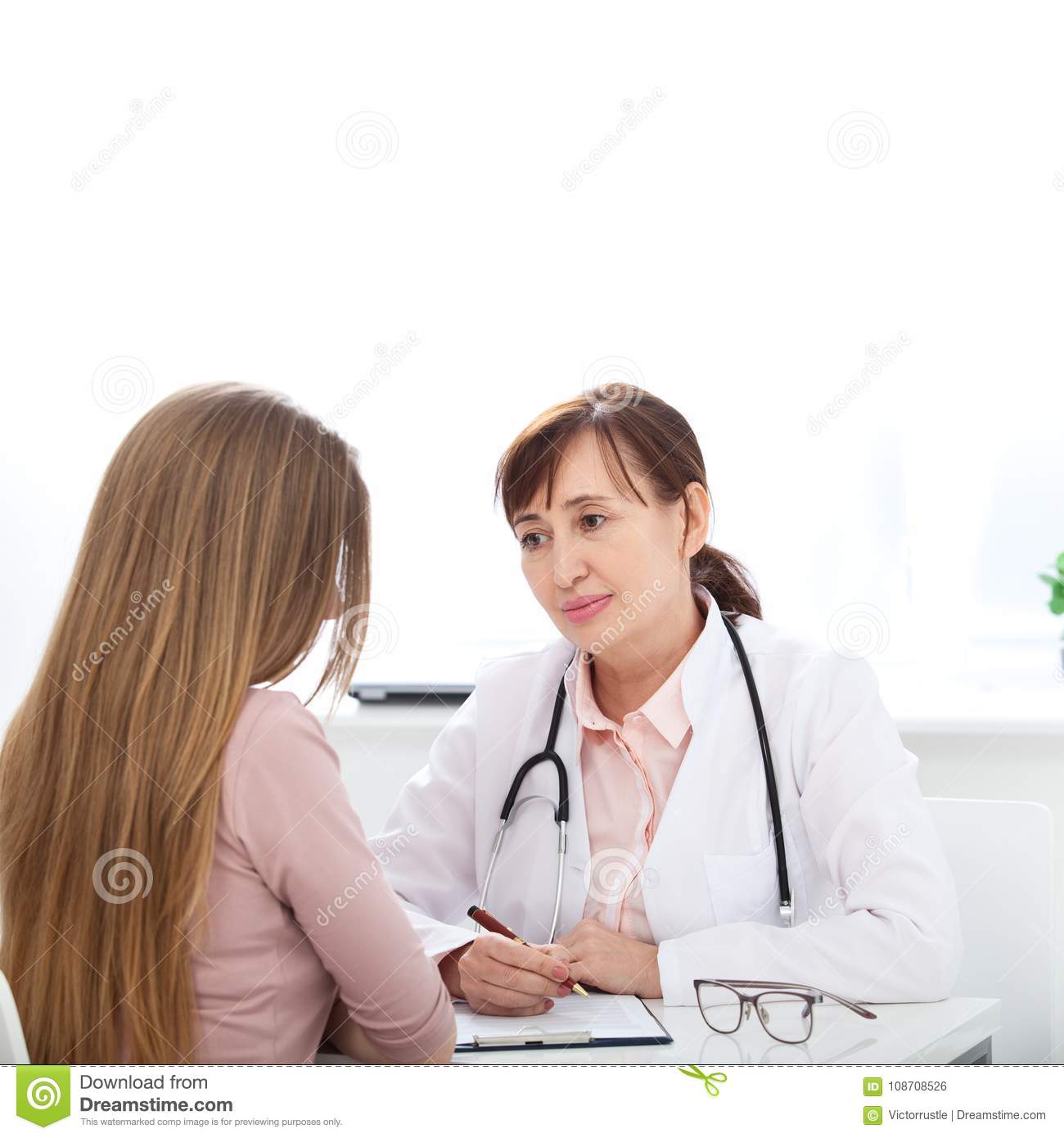 Doctor Explaining Diagnosis To Her Female Patient Stock Photo