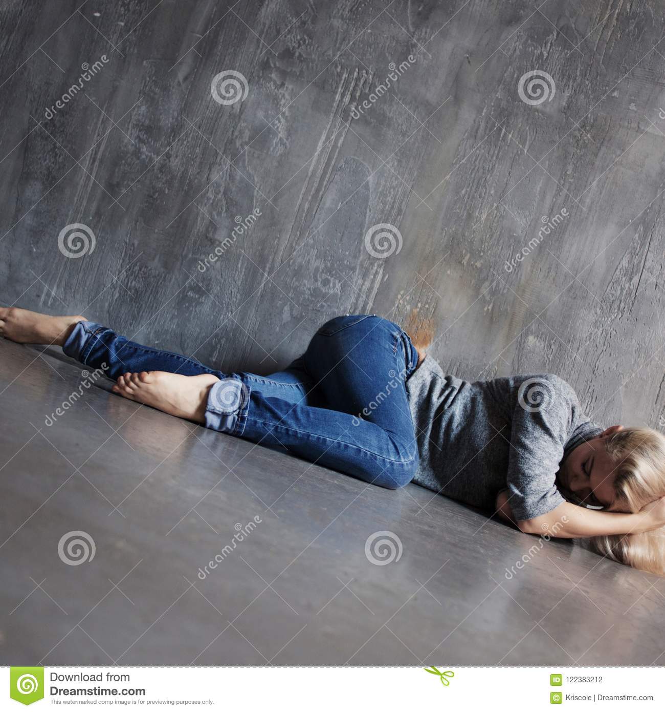 Mental Problems. Young Woman Lying On The Floor Stock Photo