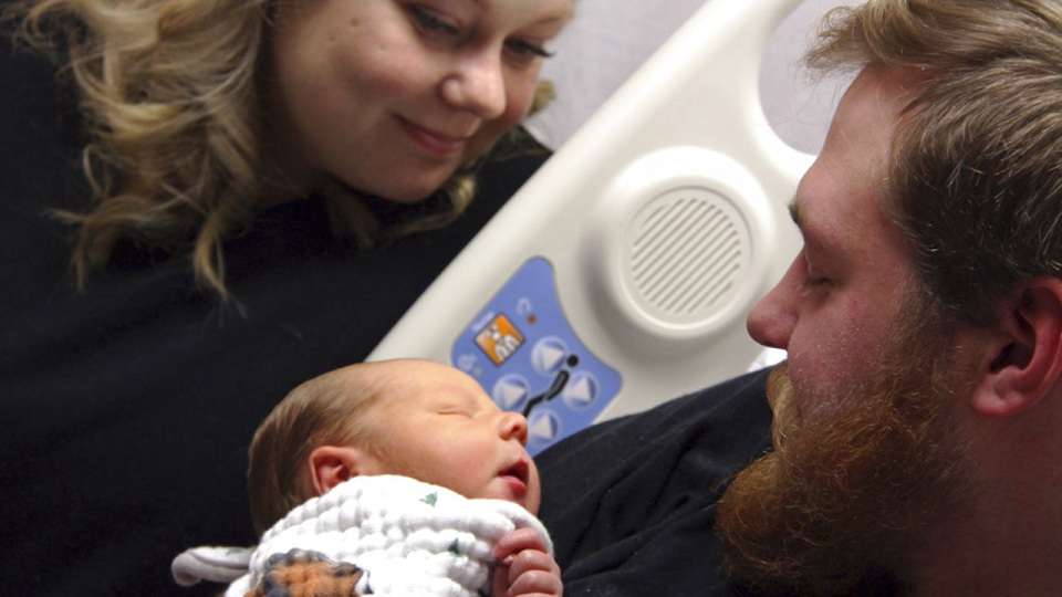 Woman saves husband, who emerges from coma just in time to see son